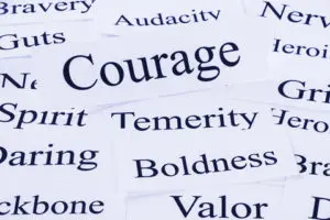 A close up of the word courage on paper