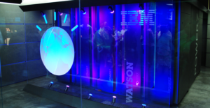 A blue lit up room with people standing around.