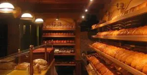 A bakery with many shelves of baked goods.