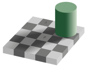 A green cylinder sitting on top of a chess board.