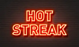 A neon sign that reads " hot streak ".
