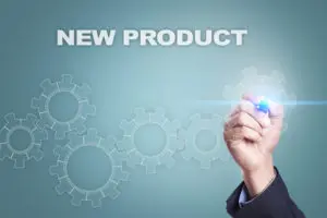 A person writing on the screen of an interactive whiteboard.