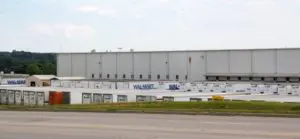 A large building with a lot of windows on the side.