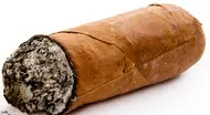 A close up of a cigar on top of the table