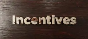 A wooden sign that says incentive.