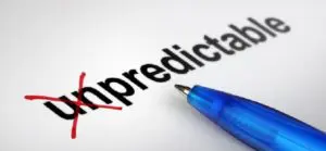 A pen is on top of an unpredictably written word.