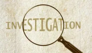 A magnifying glass over the word investigation.