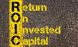A road with the words return on invested capital written in yellow paint.