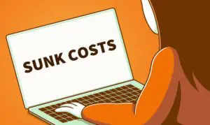 A person sitting in front of an open laptop computer.