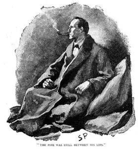 A man sitting on the ground smoking a pipe.