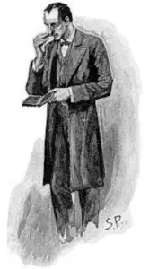 A man in a long coat and tie standing.