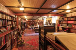 A room filled with lots of books and tables.