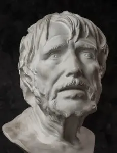 A white statue of a man with long hair and beard.