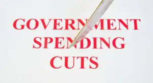 A government spending cuts sign with a pen