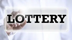 A hand is holding out the word lottery.