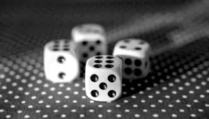 Four dice sitting on a table with black dots.