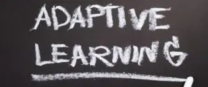 A chalkboard with the words adaptive learning written in chalk.
