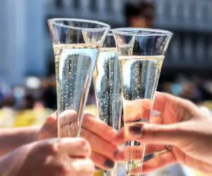 A group of people holding champagne flutes in their hands.