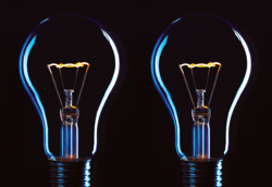 Two light bulbs are lit up in the dark.