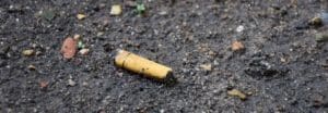 A cigarette butt laying on the ground.