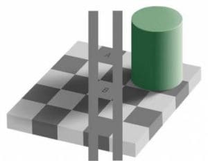 A green cylinder sitting on top of a chess board.