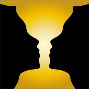 Two people facing each other with a yellow background