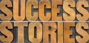 A close up of the words success stories in wood