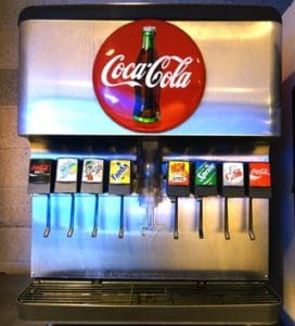 A close up of an ice machine with many different drinks