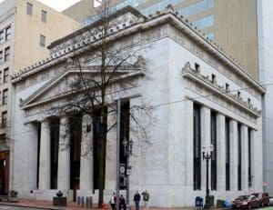 A large white building with columns on the side of it.