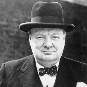 A man in a suit and hat with a bow tie.