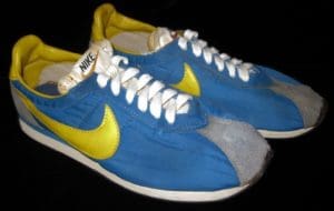 A pair of blue and yellow nike sneakers.