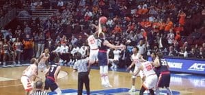 A group of men playing basketball on a court.