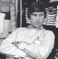 A man sitting in front of papers and a desk.